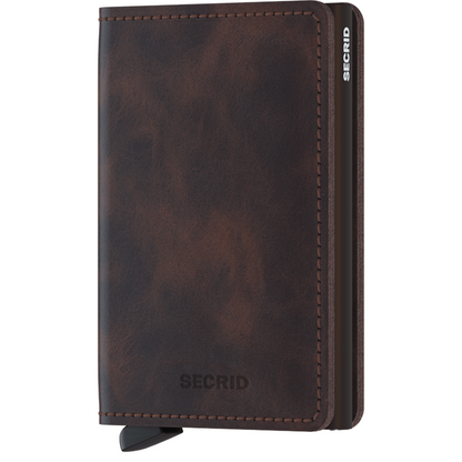 Secrid Wallets Slimwallet - Vintage, a slim brown leather cardholder with a metal core and lever for card access, offering RFID protection and ample storage.