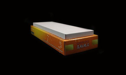 Naniwa Specialty/Super Stone 3000 210x70x10mm atop an orange box labeled Specialty Stone with Chinese characters, ideal for precise blade sharpening.
