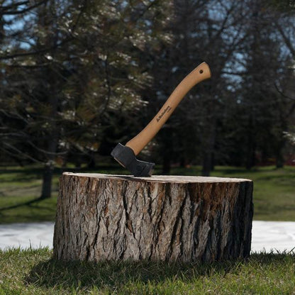 Hultafors Hultan Hatchet embedded in a tree stump, showcasing its sturdy American hickory handle and Swedish carbon steel blade, ideal for campsite tasks.