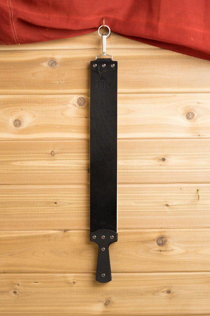 Ezra Arthur English Bridle Strop, a durable black leather strop with a handle and swivel clip, ideal for honing straight razors, ensuring lasting sharpness.