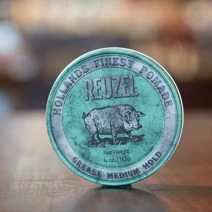 Reuzel Grease Medium Green pomade tin, featuring the iconic pig logo, offers medium-strong hold and shine for short to medium hair, ideal for slicked-back styles.