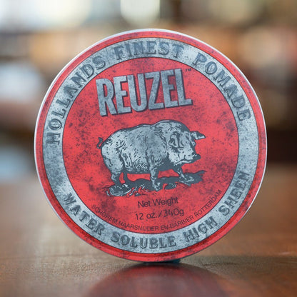 Reuzel Pomade Regular Red tin, 12 oz, featuring the iconic pig logo, offers high-shine, medium-hold styling ideal for classic looks, suitable for all hair lengths.