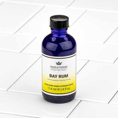 Henri et Victoria Bay Rum Aftershave Splash, 114ml cobalt-blue bottle, offers a soothing, traditional formula with floral and citrus notes for a refreshing post-shave experience.