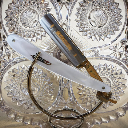 Dovo Pearl Straight Razor, Imitation Pearl Handle, 5/8, displayed on a stand, showcasing gold-tone blade and classic design, ideal for traditional wet shaving.