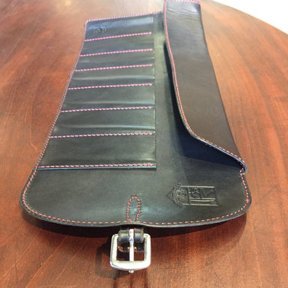 Odegard Seven Straight Razor Roll, a handcrafted black leather case with red stitching, features multiple pockets for razors, showcasing premium craftsmanship by Odegard in Athabasca.