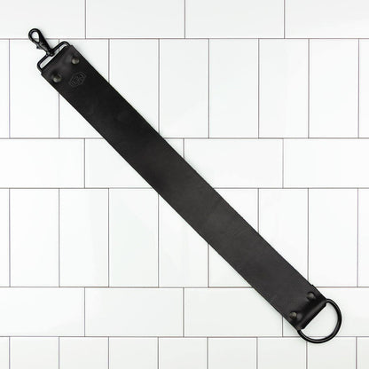 Horace and Jasper Leather Hanging Strop with black leather strap, metal clasp, and D-ring, ideal for maintaining razor sharpness.