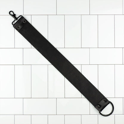 Horace and Jasper Leather Hanging Strop with a black webbing strap, lobster-style clasp, and metal O-ring, designed for effective blade maintenance.