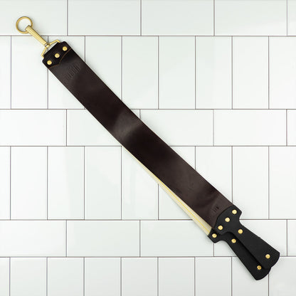 Ezra Arthur Cordovan strop with brass hardware, featuring a hanging ring and leather handles, ideal for honing straight razors and prolonging blade life.
