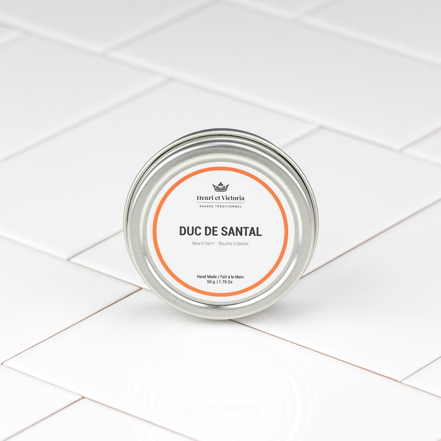 Henri et Victoria Duc de Santal Beard Balm in a silver tin, featuring a simple label, exemplifies classic shaving elegance and craftsmanship.