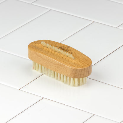 Kent of England Aqua Nail Brush on a white tile; features two rows of bristles for effective cleaning and detailing, reflecting timeless quality from a historic brushmaker.