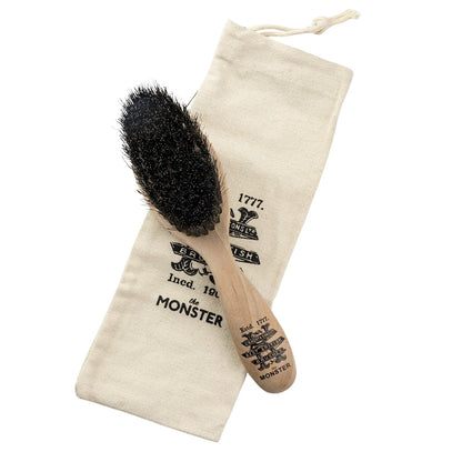 Kent of England Monster Beard Brush, Horse & Nylon Blend BRD5, features an oval head with densely packed bristles on a turned-wood handle, resting on a canvas pouch.