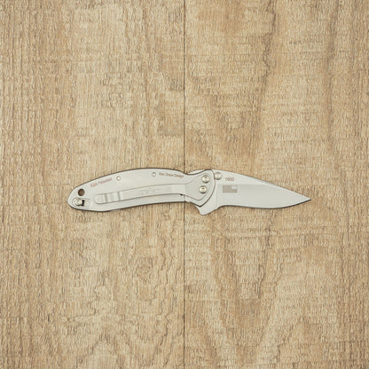 Kershaw Chive stainless-steel folding pocket knife, open with brushed silver handle and blade, ideal for small tasks and easy to carry.