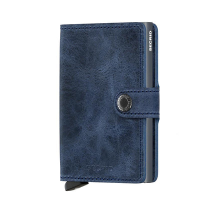 Secrid Wallets Miniwallet - Vintage: A navy-blue leather card wallet with a snap-closure, featuring Secrid's metal card-holder for secure, stylish card access.