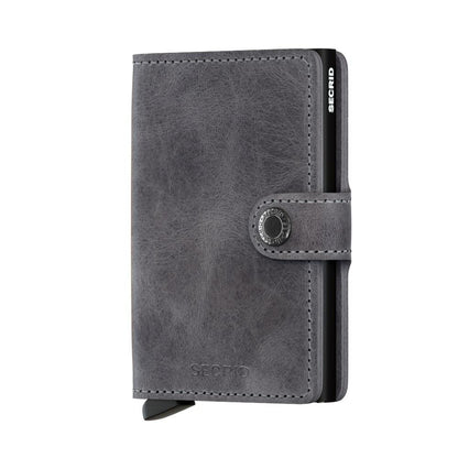 Secrid Wallets Miniwallet - Vintage: Gray leather card wallet with snap closure and slide-out mechanism, holds 2-6 cards, bills, and more. RFID blocking, hand-made in Holland.
