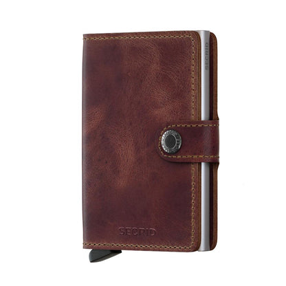 Secrid Wallets Miniwallet - Vintage: Brown leather minimalist wallet with snap-closure, featuring a slim aluminum card-protector and lever for easy card access. RFID blocking, holds 2-6 cards.