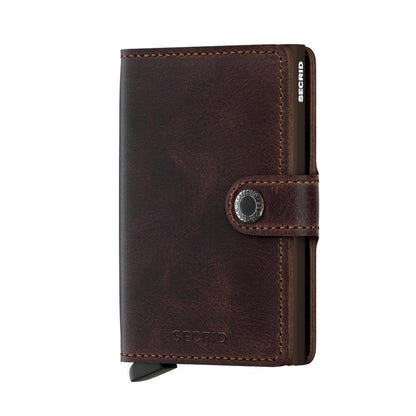 Secrid Wallets Miniwallet - Vintage: Compact dark brown leather wallet with a metal Cardprotector, snap closure, and lever for easy card access. Hand-made in Holland.