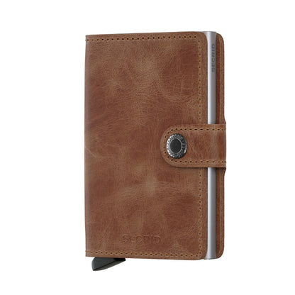 Secrid Wallets Miniwallet - Vintage, a compact brown leather wallet with snap-closure and integrated metal card-holder, offering secure card storage and RFID blocking.
