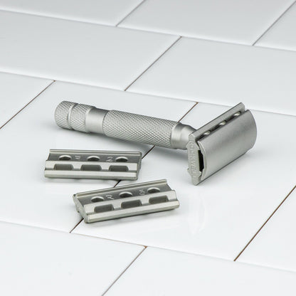 Kent's Best Shaving Kit features a traditional metal safety razor with knurled handle, two interchangeable base plates, embodying quality and enduring performance for an excellent shave.