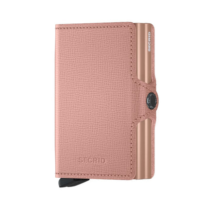 Secrid Wallets Twinwallet, a rose-pink leather cardholder with an aluminum Cardprotector, holds 10-12 cards. Features Secrid's signature lever for easy card access.