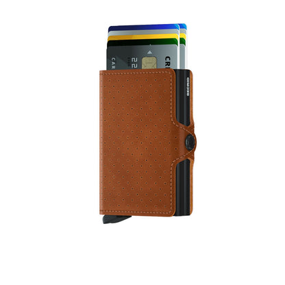 Secrid Wallets Twinwallet with perforated brown leather cover, showcasing partially fanned cards and Secrid's signature lever for easy access. Holds 2-6 cards, cash, and more.