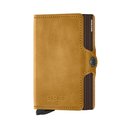 Secrid Wallets Twinwallet in tan leather with card-protecting mechanism. Holds 10-12 cards, cash, business cards, and more, offering style and organization.