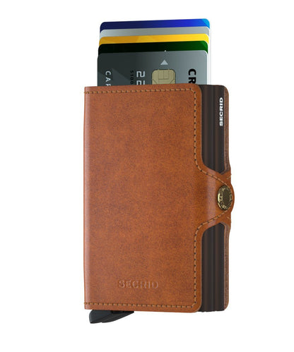 Secrid Wallets Twinwallet in brown leather with partially deployed cards from its slide-out mechanism; holds 2-6 cards, cash, and business cards. Hand-made, RFID blocking.