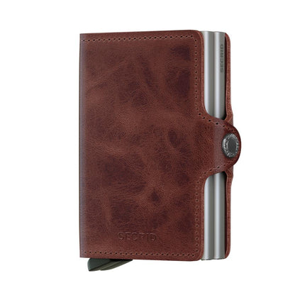 Secrid Wallets Twinwallet with brown leather cover and aluminum core, featuring a lever for card access, snap closure, holds 10-12 cards, cash, and business cards.