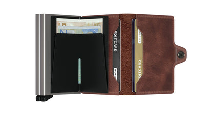 Secrid Wallets Twinwallet features a metal card-holder with cash-clip and a leather fold-over section, ideal for organizing 10-12 cards and cash efficiently.