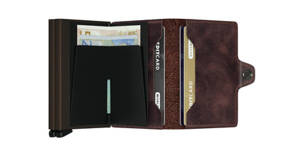 Secrid Wallets Twinwallet featuring a bi-fold design with a metal money-clip, leather card slots, and snap closure, perfect for organized card storage and cash.