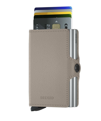 Secrid Wallets Twinwallet in gray leather, showcasing its slim design with fanned-out cards, metal slide tab, and RFID-blocking feature for stylish, secure organization.