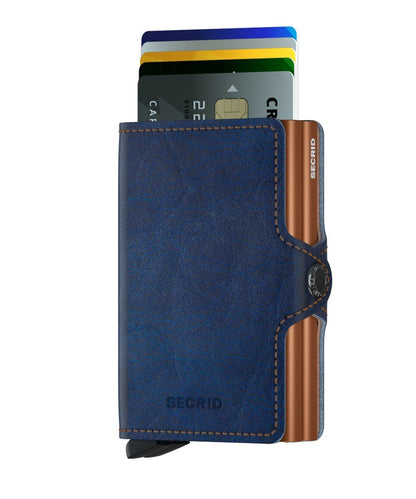 Secrid Wallets Twinwallet in blue leather with copper metal, ejects cards stylishly, holds 10-12 cards, cash, and business essentials. RFID-blocking, handmade in Holland.