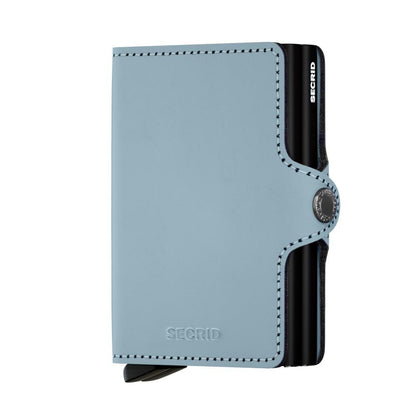 Secrid Wallets Twinwallet: Compact card wallet with a light blue leather exterior, black stitching, and a metal card-eject mechanism for stylish, organized card access.