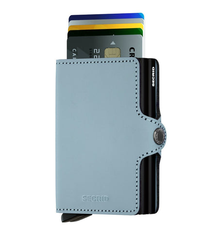 Secrid Wallets Twinwallet in light blue leather, featuring a sleek design with a metal mechanism for easy card access and RFID protection, holds 10-12 cards securely.