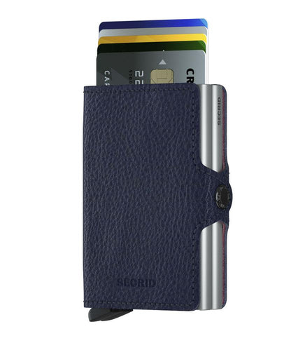 Secrid Wallets Twinwallet in pebbled navy-blue leather with aluminum core, showcasing partially ejected cards via the signature lever for organized, stylish access.