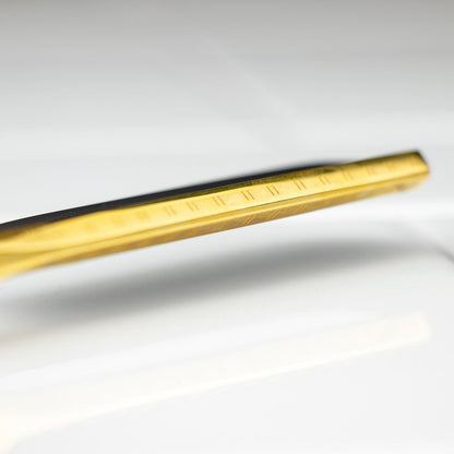 Dovo Bismarck Straight Razor 6/8” close-up shows a polished, tapered gold-colored metal rod with engraved markings, highlighting its exquisite craftsmanship and design.