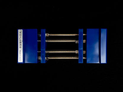 Stone Holder Spring Loaded: A compact Japanese clamping jig with plastic jaws, designed for securing sharpening stones effortlessly using spring-loaded tension via threaded rods.