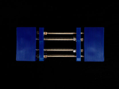 Stone Holder Spring Loaded with blue ribbed plastic jaws connected by steel rods, designed to securely grip stones without manual adjustments.