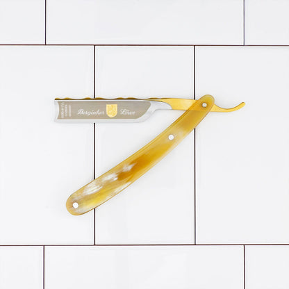 Dovo Straight Razor, Bergischer Horn Handle, 5/8, featuring a Swedish Carbon Steel blade with a unique horn-style handle, laid open on a white tiled background.