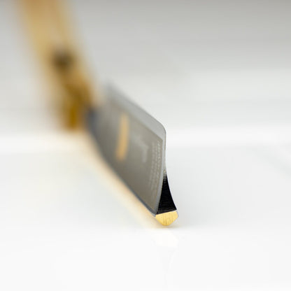 Macro view of Dovo Straight Razor's sharpened chisel blade edge and wooden handle, highlighting precision craftsmanship. Perfect for detailed shaving, reflecting Kent of Inglewood's quality ethos.