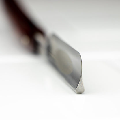 Dovo Carpe Diem 5/8” Straight Razor with rounded toe and beveled edge, focusing on blade detail, ideal for a precise, classic shave.