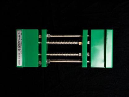 Stone Holder Spring Loaded with green jaws secures sharpening stones effortlessly using a spring mechanism, perfect for precision honing. Made in Japan, ideal for shaving tools.