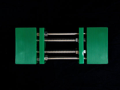 Stone Holder Spring Loaded with rib-textured jaws and parallel metal rods, designed for secure stone placement without manual adjustments.