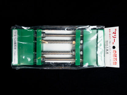 Stone Holder Spring Loaded: A compact Japanese whetstone holder with green jaws, threaded rods, and springs for easy stone clamping during sharpening, enhancing your tool maintenance experience.