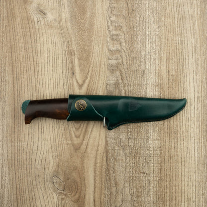 Helle Knives Speider 90mm Hunting Knife sheathed in green leather, featuring a secure brass button. Ideal for carving, ensuring superior control and protection.
