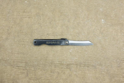 Higo Knife: Traditional Japanese folding pocket knife with a single-edged blade and metal handle featuring Kanji, crafted by Mitsuo Nagao using SK carbon steel.