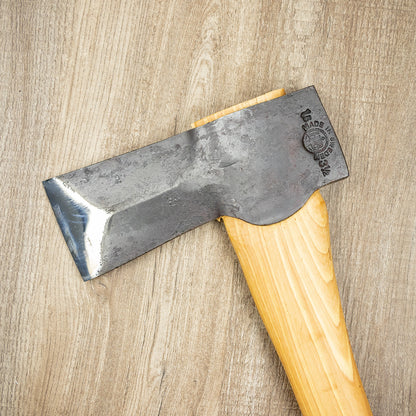 Hultafors Hult Splitting Axe with a wood handle and stamped Swedish steel head, ideal for log splitting, displayed on a wooden surface.
