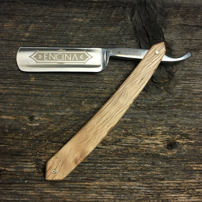 Dovo Encina Straight Razor with Spanish Oak handle, 6/8” blade, etched with ENCINA and DOVO Solingen on tang, displayed open on wood.