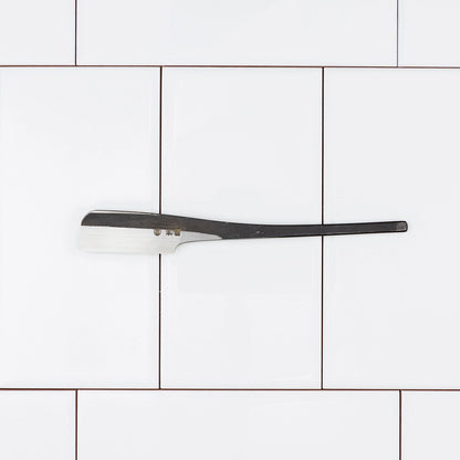 Iwasaki Kamisori, a handcrafted steel razor with a long handle and straight-edged blade, designed for precision shaving and exceptional edge retention.