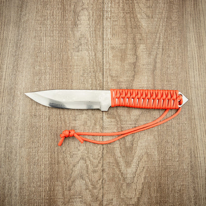 Seki Kanetsune SHU-KARASU Outdoor Knife 125mm with a steel blade and orange paracord-wrapped handle, displayed on a wooden surface.
