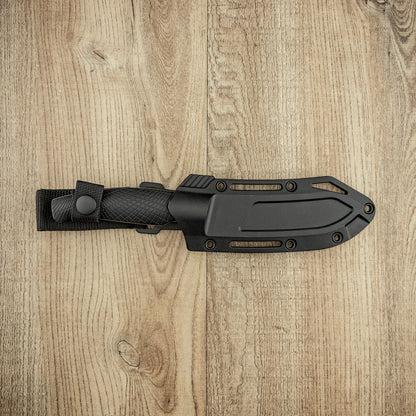 Kershaw Camp 5 knife in a black sheath, features a textured grip and multiple attachment slots, perfect for bushcraft and hunting tasks.